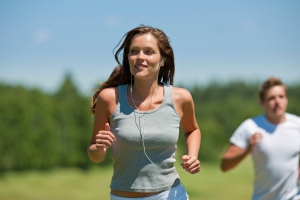 Brown hair woman with headphones jogging